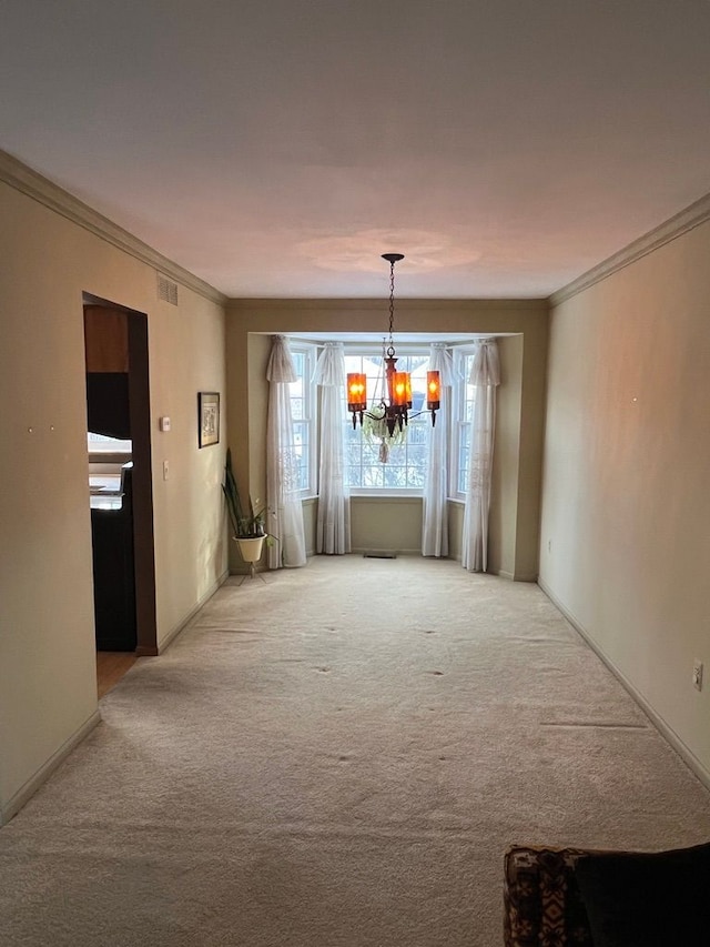 unfurnished dining area featuring ornamental molding, carpet, and a notable chandelier