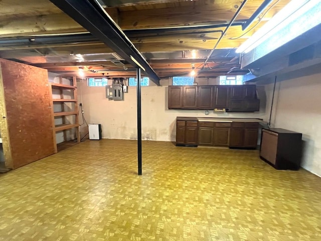 basement with electric panel and fridge