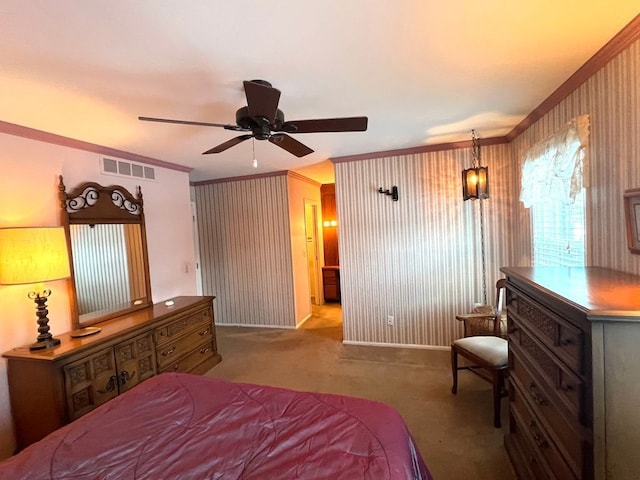 carpeted bedroom with ornamental molding and ceiling fan