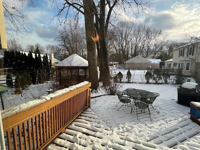 snow covered patio featuring grilling area