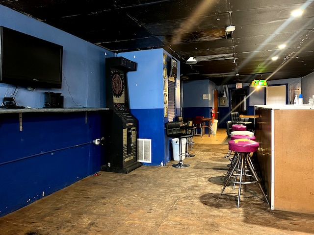 basement featuring indoor bar