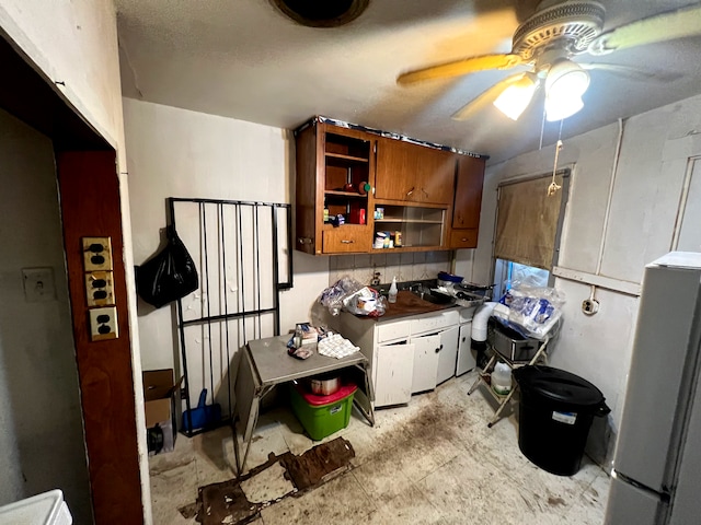 kitchen featuring ceiling fan and fridge