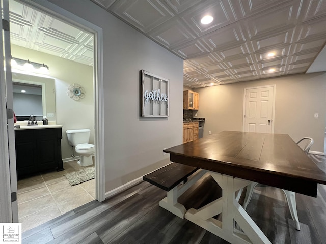 dining space featuring sink and light wood-type flooring