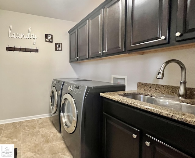 washroom featuring sink, cabinets, washer and clothes dryer, and light tile patterned floors