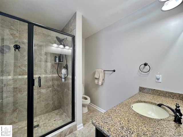 bathroom with walk in shower, tile patterned floors, vanity, and toilet