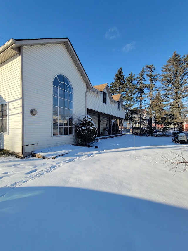 snow covered property with a garage