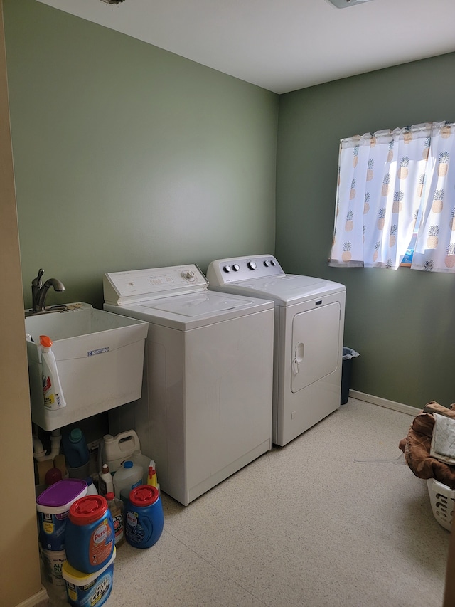 washroom featuring washer and clothes dryer and sink