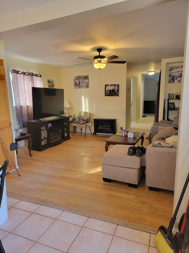 living room featuring ceiling fan and light tile patterned flooring