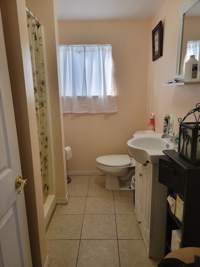 bathroom featuring walk in shower, tile patterned flooring, plenty of natural light, toilet, and vanity