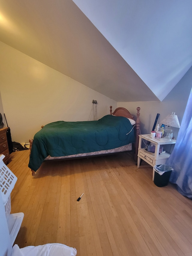 bedroom with wood-type flooring and lofted ceiling