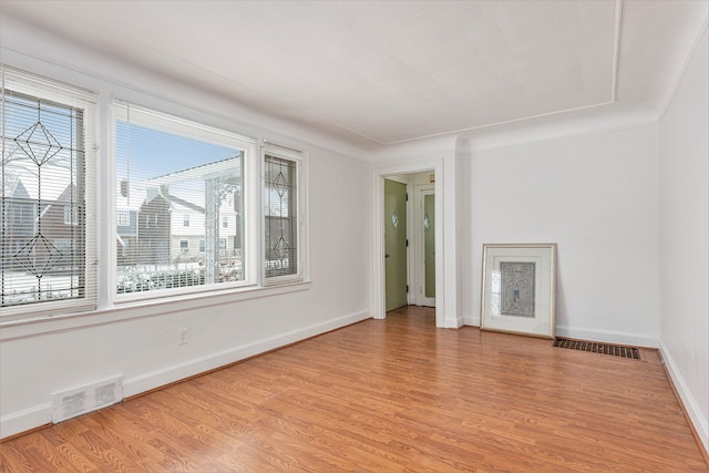 spare room featuring light hardwood / wood-style flooring