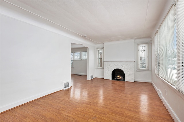 unfurnished living room with a fireplace and wood-type flooring