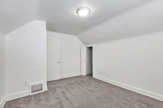 bonus room with lofted ceiling and carpet floors