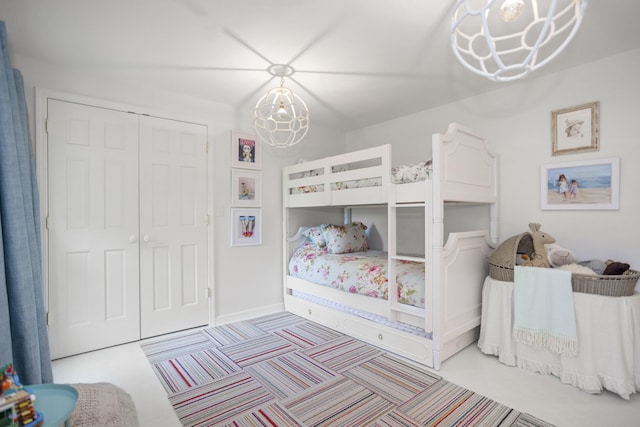 bedroom with a notable chandelier and a closet