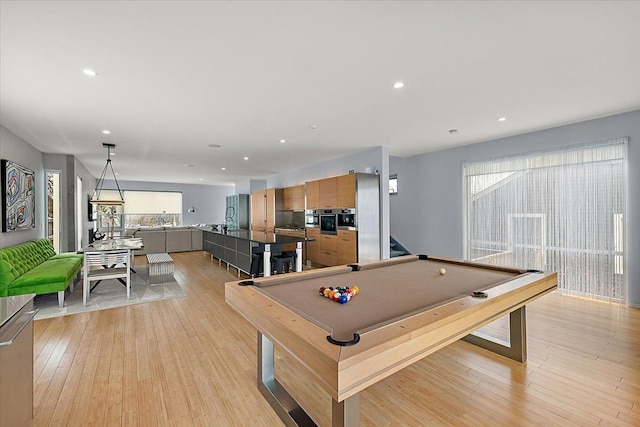 recreation room with pool table and light hardwood / wood-style floors