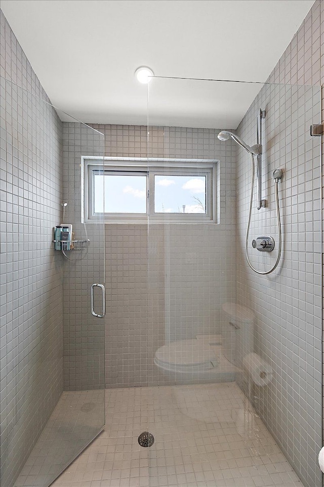 bathroom with a shower with door