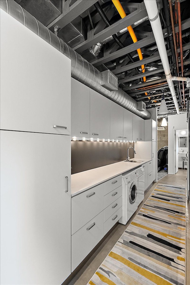 laundry room featuring washer / clothes dryer and sink