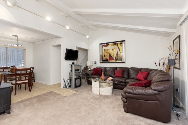 living room featuring lofted ceiling with beams and light tile patterned flooring