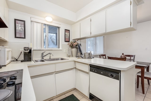 kitchen with sink, white cabinetry, dishwasher, kitchen peninsula, and a wealth of natural light