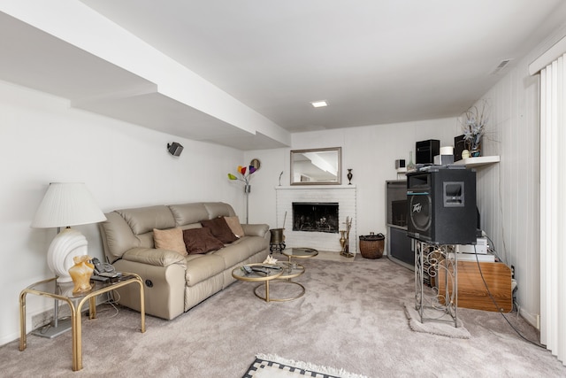 carpeted living room with a brick fireplace