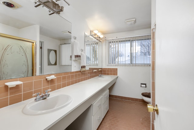 bathroom featuring toilet, vanity, tile patterned floors, decorative backsplash, and an enclosed shower