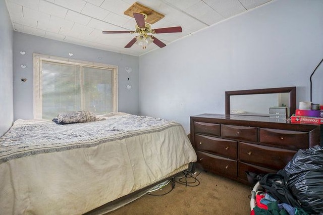 bedroom with ceiling fan and light carpet