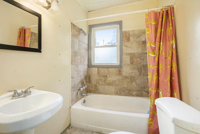 full bathroom with toilet, shower / bathtub combination with curtain, and sink