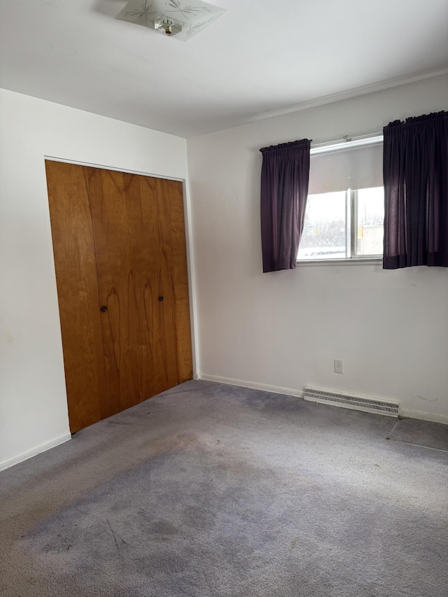 unfurnished bedroom with carpet floors and a closet