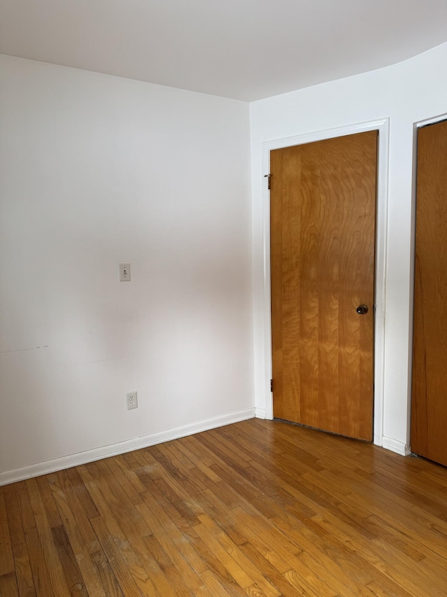 unfurnished room with hardwood / wood-style floors