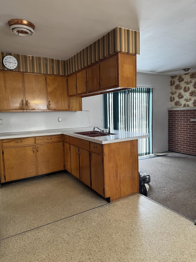 kitchen featuring kitchen peninsula and sink