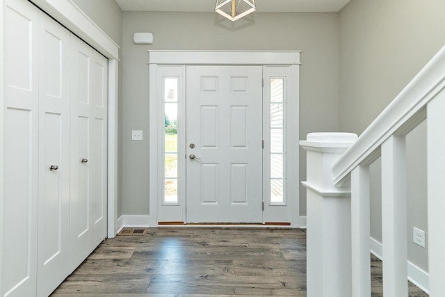 entryway with dark wood-type flooring