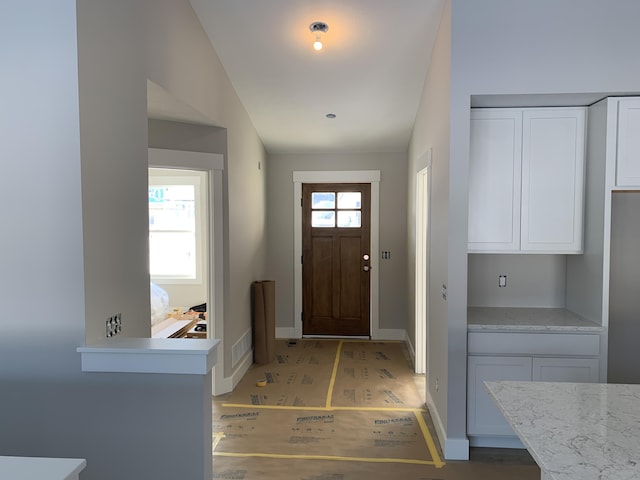 foyer featuring vaulted ceiling