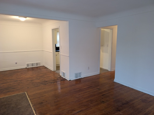 spare room featuring dark hardwood / wood-style floors