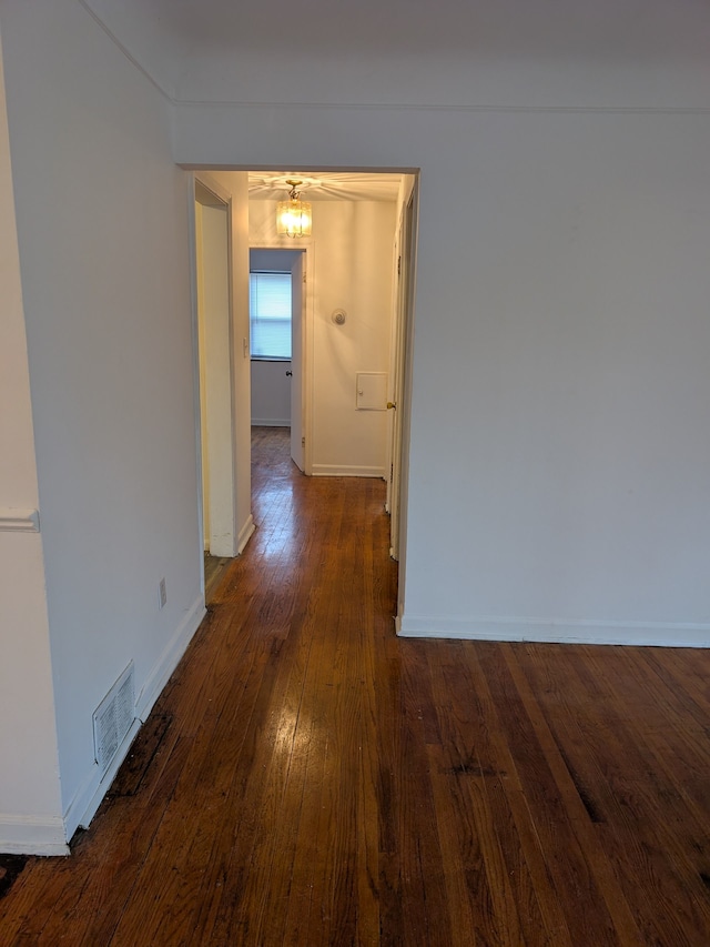 hallway featuring dark hardwood / wood-style flooring