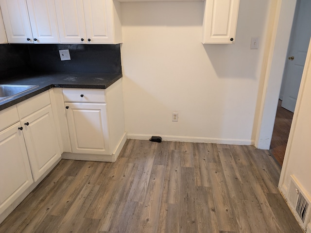 washroom with dark hardwood / wood-style flooring and sink