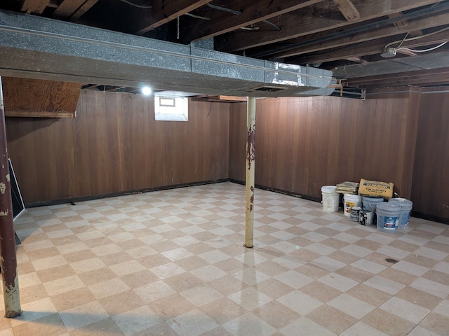 basement featuring wood walls