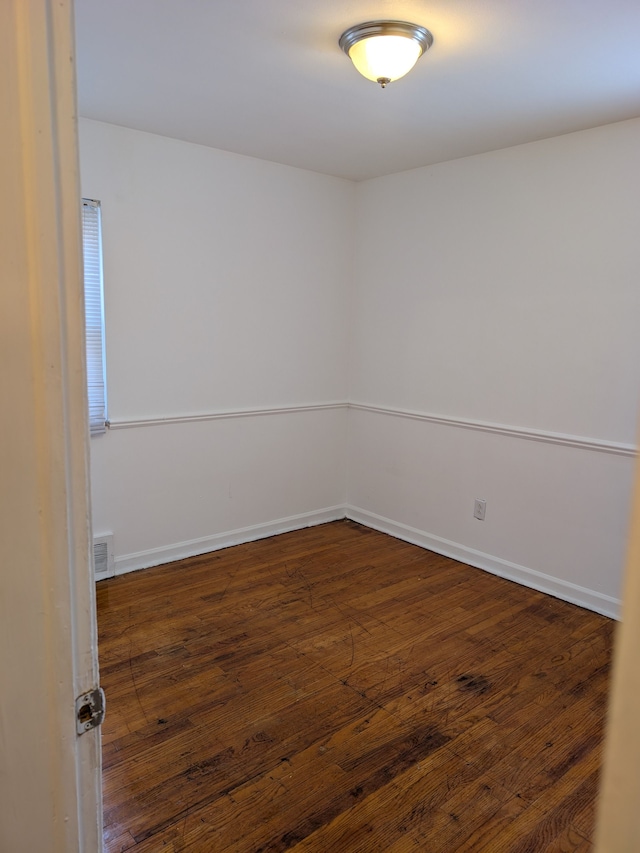 empty room featuring dark wood-type flooring