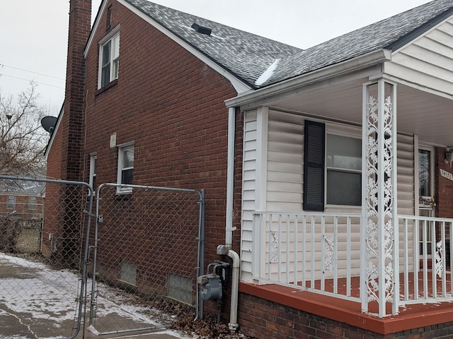 view of snow covered exterior featuring covered porch