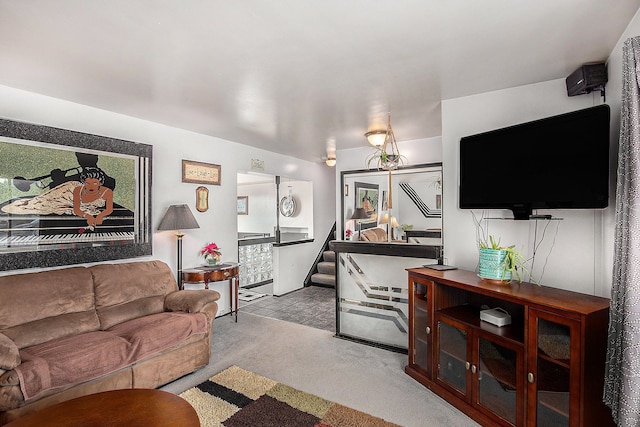 living area featuring carpet and stairway