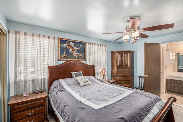 bedroom with connected bathroom and a ceiling fan