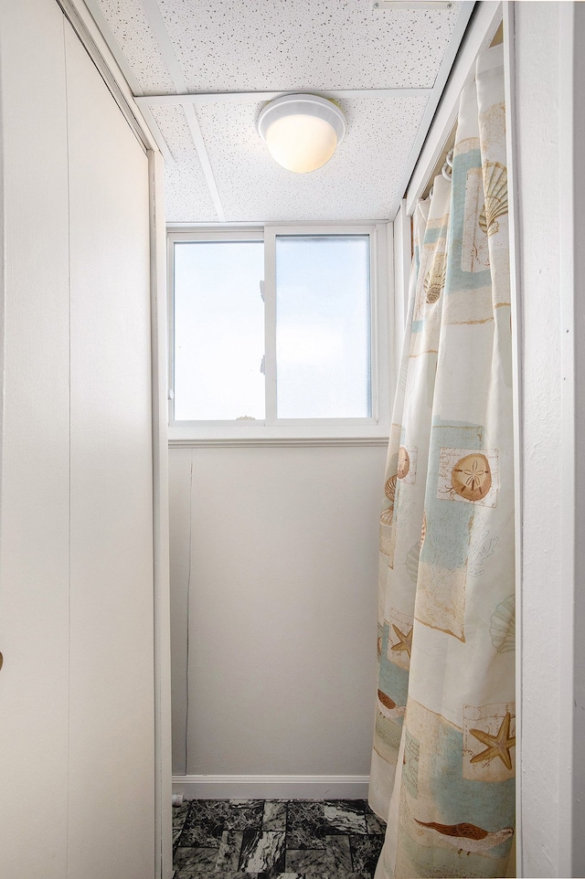 bathroom with baseboards and marble finish floor