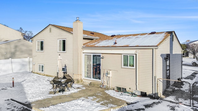 view of snow covered rear of property