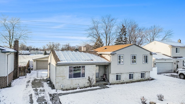 split level home with a garage and an outdoor structure