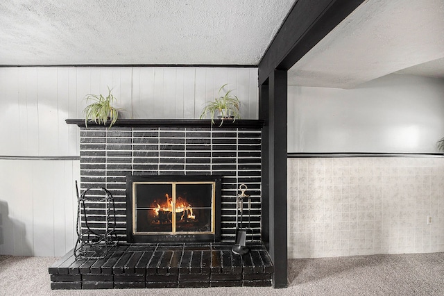 room details featuring carpet floors, a fireplace, and a textured ceiling