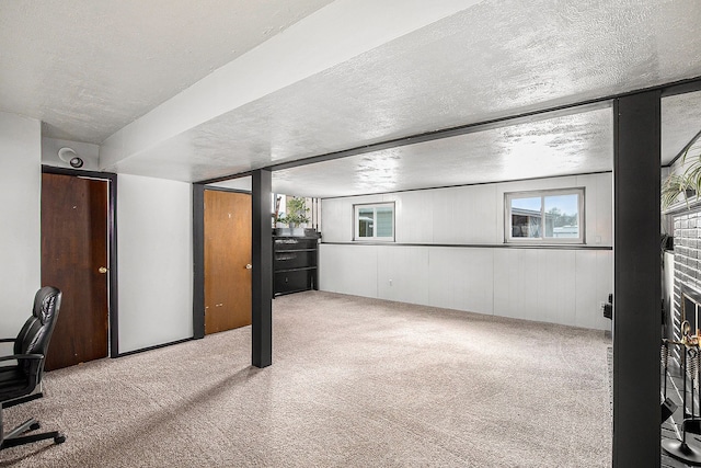 below grade area with a textured ceiling and carpet