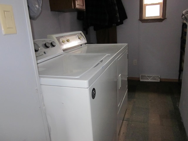 washroom featuring washer and clothes dryer and cabinets