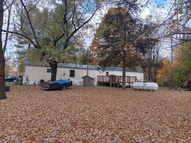 exterior space with a deck and a storage unit