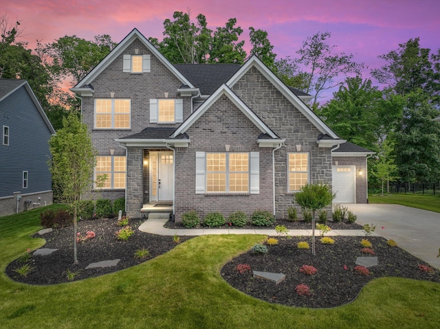 craftsman inspired home featuring a yard and a garage