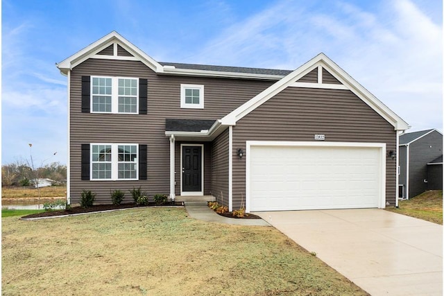 view of front of home with a garage and a front lawn