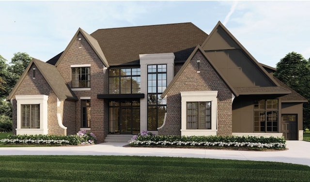 view of front facade with brick siding and a front yard